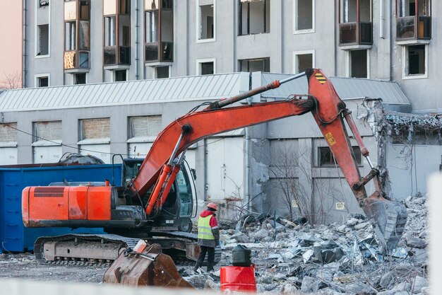 cleaning-construction-debris-with-bucket-excavator-building-demolition-heavy-machinery_549949-492