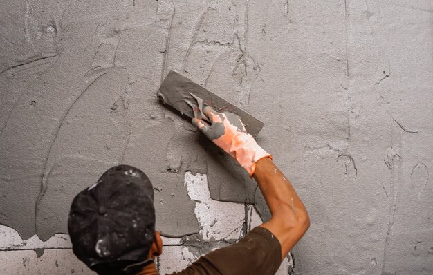 hand-worker-plastering-cement-wall-building-house-construction-site_34152-2751