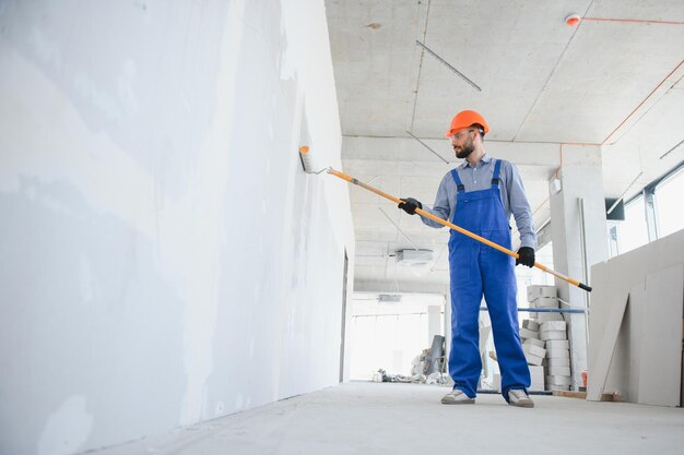 painter-man-painting-wall-with-paint-roller_255667-47384