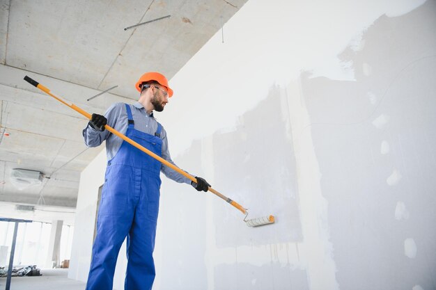 painter-man-painting-wall-with-paint-roller_255667-47388