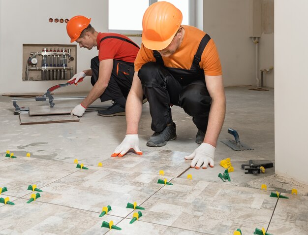 workers-are-installing-ceramic-tiles-floor_191163-1567